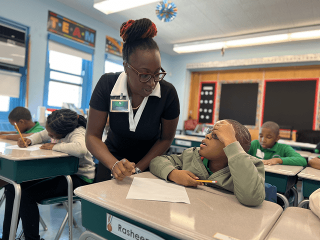 Teacher helping student with homework